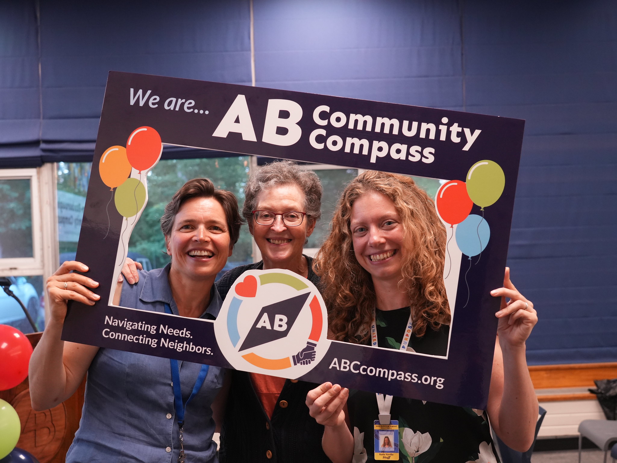 people in "we are community compass" frame