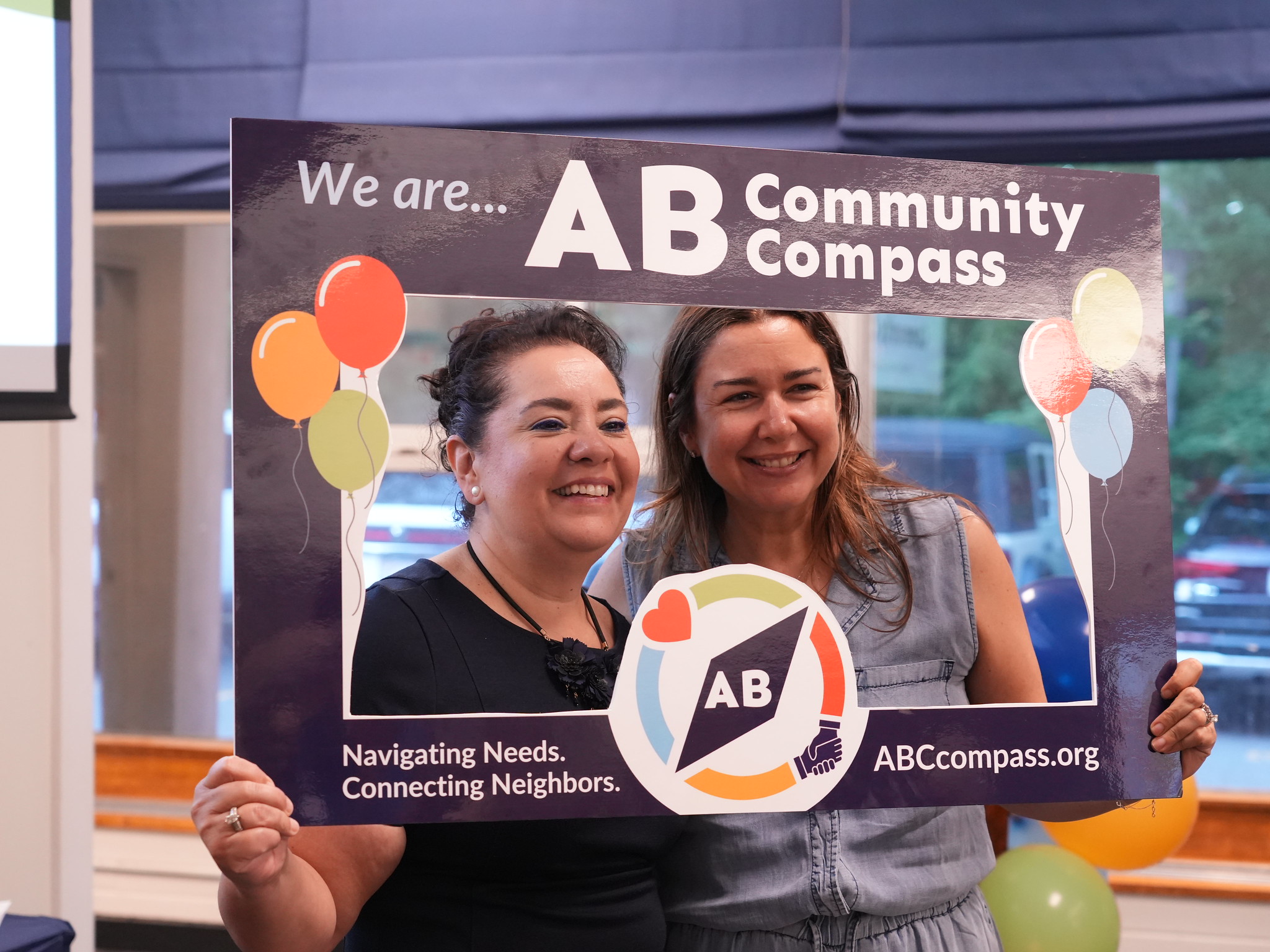 people in "we are community compass" frame