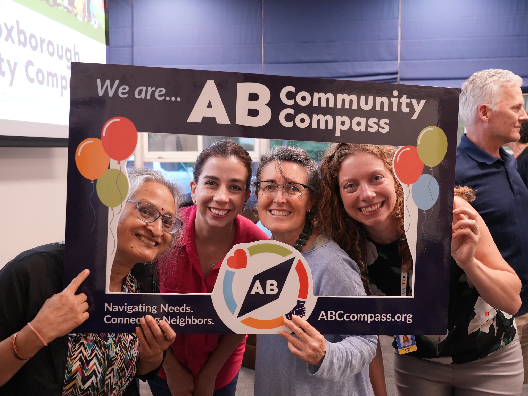 people in "we are community compass" frame